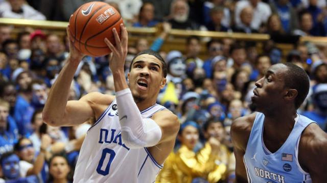 Feb 9, 2017; Durham, NC, USA; Duke Blue Devils forward Jayson Tatum (0) drives against North Carolina Tar Heels forward Theo Pinson (1) in the second half of their game at Cameron Indoor Stadium. Mandatory Credit: Mark Dolejs-USA TODAY Sports